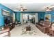 Bright living room featuring a large TV and comfortable seating at 399 Foxhill Dr, Debary, FL 32713