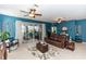 Spacious living room with leather furniture and access to a screened porch at 399 Foxhill Dr, Debary, FL 32713