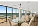 Ocean view dining room with glass table and chairs at 2555 S Atlantic Ave # 207, Daytona Beach Shores, FL 32118
