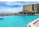 Resort-style pool with adjacent bar and lounge area at 2301 S Atlantic Ave # 236, Daytona Beach Shores, FL 32118