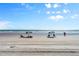 Beach access with umbrellas and chairs, perfect for relaxation at 2301 S Atlantic Ave # 236, Daytona Beach Shores, FL 32118