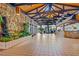 Spacious lobby with tile floors, stone walls, and tropical plants at 2301 S Atlantic Ave # 236, Daytona Beach Shores, FL 32118