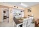 Simple kitchen with white cabinets and dining table at 2301 S Atlantic Ave # 306, Daytona Beach Shores, FL 32118