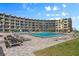 Resort-style pool with surrounding building and seating at 2301 S Atlantic Ave # 306, Daytona Beach Shores, FL 32118