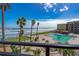 Oceanfront pool with lounge chairs and picnic tables at 2301 S Atlantic Ave # 306, Daytona Beach Shores, FL 32118