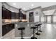 Modern kitchen with dark cabinets, granite counters, and breakfast bar at 537 Champion Ridge Dr, Daytona Beach, FL 32124
