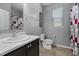 Clean bathroom with a white toilet and red shower curtain at 537 Champion Ridge Dr, Daytona Beach, FL 32124
