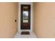 Dark brown front door with glass inserts and a welcome mat at 537 Champion Ridge Dr, Daytona Beach, FL 32124