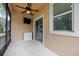 Covered screened porch with ceiling fan and small fridge at 537 Champion Ridge Dr, Daytona Beach, FL 32124