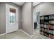 Bright entryway with front door, built-in shelving, and nearby bathroom at 537 Champion Ridge Dr, Daytona Beach, FL 32124