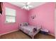 Charming bedroom with a white bed frame and pink walls at 537 Champion Ridge Dr, Daytona Beach, FL 32124