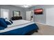 Main bedroom with dresser, large bed, and access to additional rooms at 537 Champion Ridge Dr, Daytona Beach, FL 32124