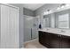 Bathroom with double vanity, large mirror, and shower at 537 Champion Ridge Dr, Daytona Beach, FL 32124
