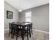 Dining area with square table and six chairs, light walls, and window at 537 Champion Ridge Dr, Daytona Beach, FL 32124