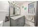 Bathroom with granite vanity, updated fixtures, and decorative art at 246 Angeles Rd, Debary, FL 32713