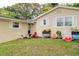 Beige home with white shutters, landscaping, and toys at 246 Angeles Rd, Debary, FL 32713