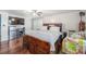 Main bedroom with wood floors, a king-size bed and a TV at 246 Angeles Rd, Debary, FL 32713