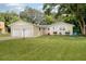 Two-car garage, light beige exterior, and nicely landscaped lawn at 246 Angeles Rd, Debary, FL 32713