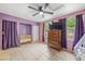 Pink bedroom with crib, dresser, and ceiling fan at 246 Angeles Rd, Debary, FL 32713