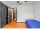 Small bedroom with hardwood floors and a blue bedspread at 333 Beresford Ave, Deland, FL 32724