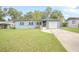 Ranch style home with a newly painted exterior, driveway, and grassy yard at 333 Beresford Ave, Deland, FL 32724