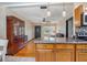 Kitchen with island, wood cabinets, and a view of the living room at 333 Beresford Ave, Deland, FL 32724