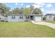 Ranch style home with light blue exterior and a spacious yard at 333 Beresford Ave, Deland, FL 32724