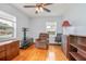 Hardwood floor bedroom with a ceiling fan and comfortable seating at 333 Beresford Ave, Deland, FL 32724
