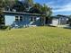 Ranch style home with light blue exterior and a spacious yard at 333 Beresford Ave, Deland, FL 32724