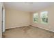 Spacious bedroom with neutral walls, carpeted floors, and large windows at 10810 Eclipse Lily Way # S, Orlando, FL 32832