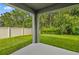 Covered patio overlooking a fenced backyard at 370 Sunset Point Dr, Ormond Beach, FL 32174