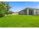 Large backyard with grassy area and home exterior at 370 Sunset Point Dr, Ormond Beach, FL 32174