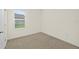 Simple bedroom with carpeted floor and window at 370 Sunset Point Dr, Ormond Beach, FL 32174