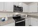 Stainless steel appliances and granite countertops in this bright kitchen at 370 Sunset Point Dr, Ormond Beach, FL 32174