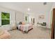 Main bedroom with plush pink bedding and en suite bathroom at 370 Sunset Point Dr, Ormond Beach, FL 32174