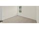 Simple bedroom with carpeted floor and window at 370 Sunset Point Dr, Ormond Beach, FL 32174