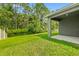 Spacious backyard with grassy lawn and covered patio at 370 Sunset Point Dr, Ormond Beach, FL 32174