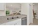 Modern kitchen with double sink, granite counters, and stainless steel dishwasher at 370 Sunset Point Dr, Ormond Beach, FL 32174