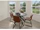 Small dining area with round table and four leather chairs, near kitchen at 370 Sunset Point Dr, Ormond Beach, FL 32174