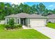 Single-story house with a two-car garage and landscaping at 370 Sunset Point Dr, Ormond Beach, FL 32174