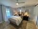 Charming bedroom with a rattan headboard, light walls, and wood-look floors at 1140 S Orlando Ave # F-16, Maitland, FL 32751