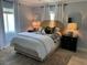 Bright bedroom featuring a stylish rattan headboard and ample natural light at 1140 S Orlando Ave # F-16, Maitland, FL 32751