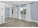 Light and airy bedroom with mirrored closet doors and wood-look flooring at 1140 S Orlando Ave # F-16, Maitland, FL 32751