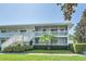 Front view of a two-story building with white railings and landscaping at 1140 S Orlando Ave # F-16, Maitland, FL 32751