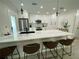 Modern kitchen with white cabinets, stainless steel appliances, and marble countertops at 1140 S Orlando Ave # F-16, Maitland, FL 32751