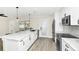 Modern kitchen with white cabinets, island, and stainless steel appliances at 1140 S Orlando Ave # F-16, Maitland, FL 32751