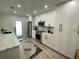 Modern kitchen with white cabinets, large island and stainless steel appliances at 1140 S Orlando Ave # F-16, Maitland, FL 32751