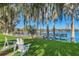 Tranquil lakefront view with dock and lush landscaping at 1140 S Orlando Ave # F-16, Maitland, FL 32751
