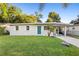 Newly renovated single story home with teal door and manicured lawn at 522 Powers Ave, Port Orange, FL 32127