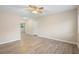 Bright living room with wood-look floors and ceiling fan at 522 Powers Ave, Port Orange, FL 32127